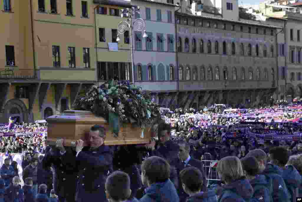 The coffin of Italian player Davide Astori is carried into the church in Florence. The 31-year-old Astori was found dead in his hotel room on Sunday after a suspected cardiac arrest before his team was set to play an Italian league match at Udinese.
