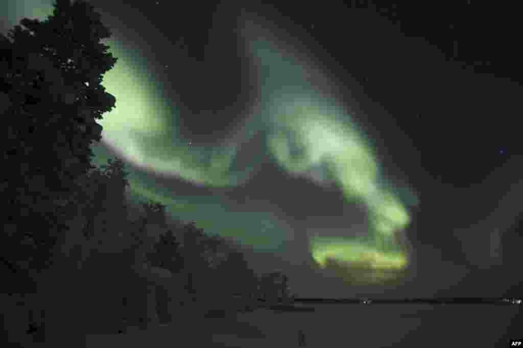 Northern lights (aurora borealis), illuminate the sky of Finnish Lapland in Inari.