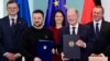 Канцлер Німеччини Олаф Шольц та президент України Володимир Зеленський позують після підписання двосторонньої угоди про зобов’язання щодо безпеки та довгострокової підтримки в Берліні, 16 лютого 2024 року. (Фото Джона МАКДУГАЛЛА / AFP)