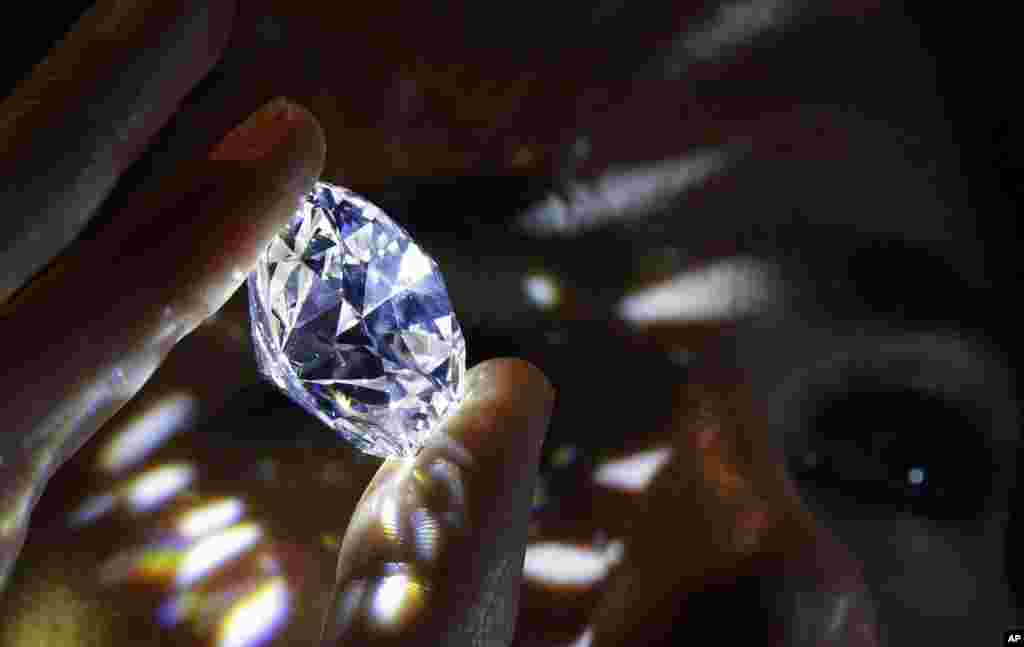 A 102.34 carat, D color and flawless white diamond held is displayed at Sotheby's auction house in London. The diamond is the world largest known round brilliant diamond to have achieved "perfection in all critical criteria - Color, Clarity, Cut and Carat", and is expected to reach considerably over $33.7 million by private sale in London.