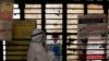 A medical worker gets ready to collect a sample from a man at a school turned into a center to conduct tests for the coronavirus disease (COVID-19), amidst its spread in New Delhi, India, June 22, 2020.