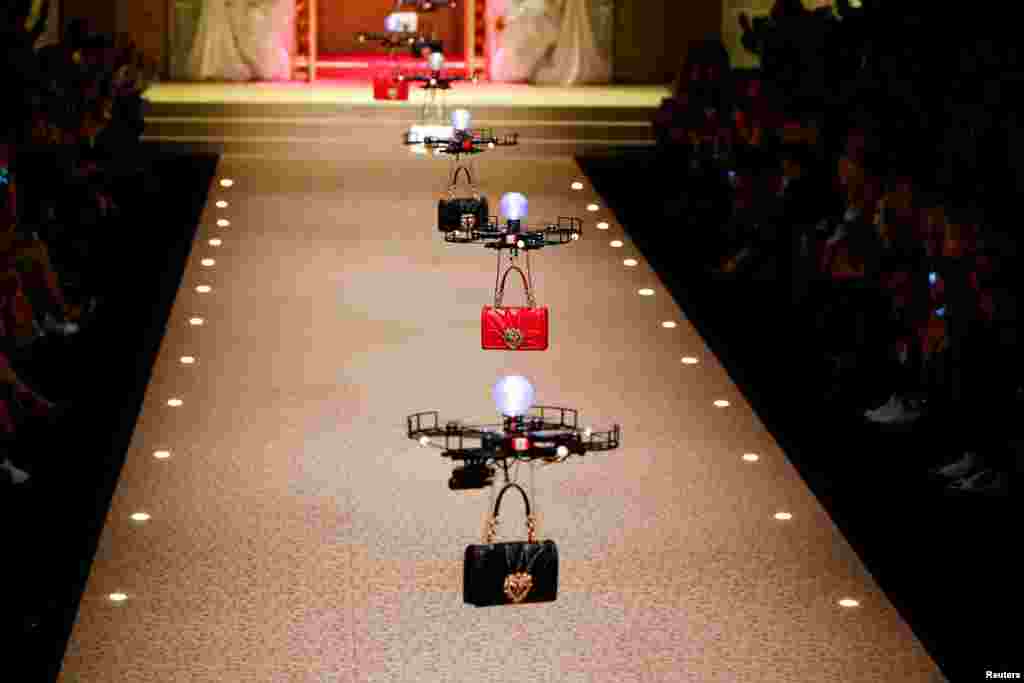 Drones carry handbags, the creations from the Dolce & Gabbana Autumn/Winter 2018 women's collection during Milan Fashion Week in Milan, Italy.