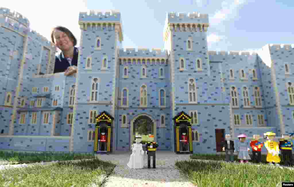 Head model maker, Paula Laughton poses for a photograph with a LEGO Windsor Castle replete with royal wedding between Britain's Prince Harry and Meghan Markle, in Windsor.
