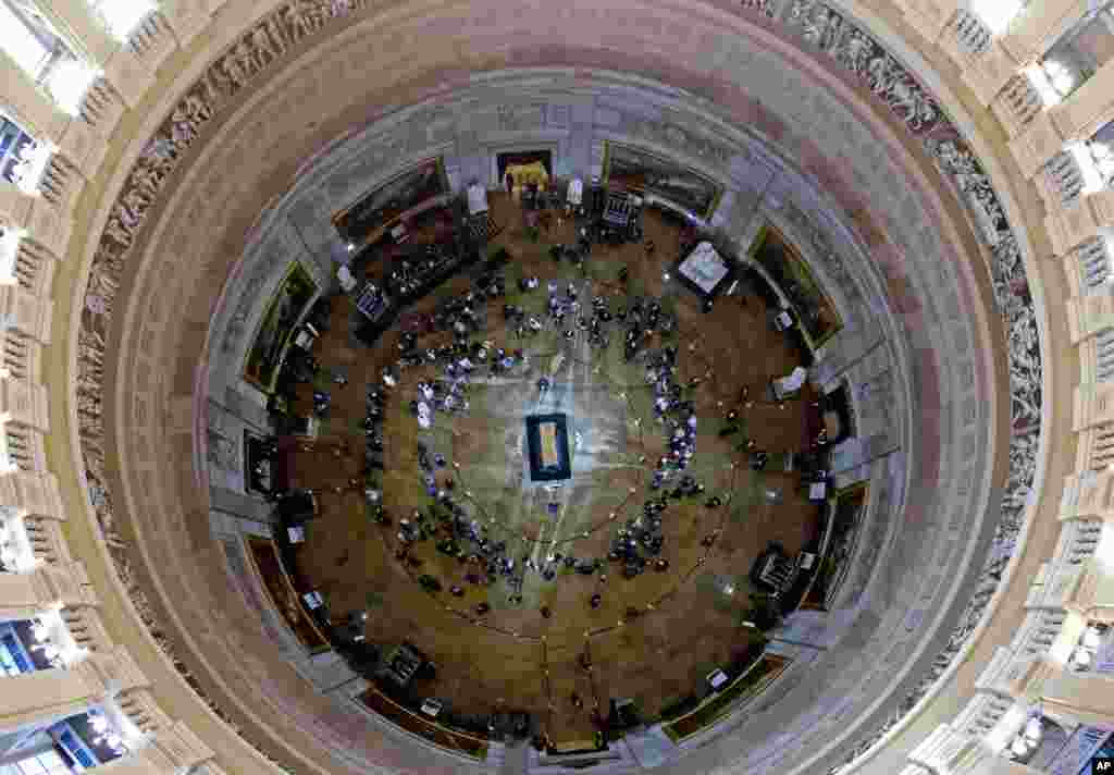 Visitors pay their respects as the casket of Reverend Billy Graham lies in honor at the Rotunda of the U.S. Capitol Building in Washington, Feb. 28, 2018. It's a rare honor for a private citizen to lie in honor at the Capitol. Graham died in his sleep at his North Carolina home. He was 99.