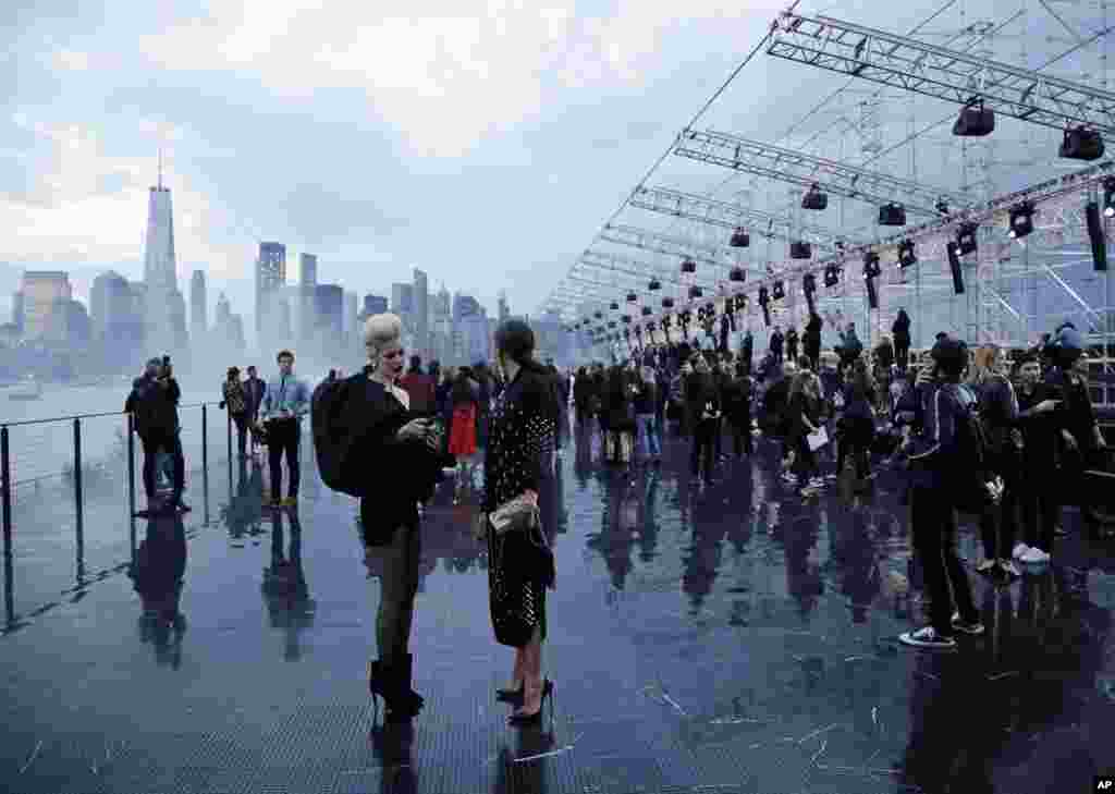 Patrons arrive for Saint Laurent Spring 2019 menswear fashion show, June 6, 2018, in Liberty Island, New York.