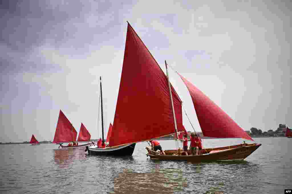 Members of a cultural sailing association take part in the so-called “Red Regatta” in Venice, Northeastern Italy.
