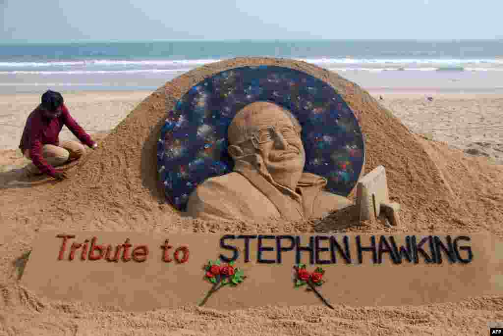 Sand artist Sudarsan Patnaik gives final touches to a sculpture in honor of British physicist and award-winning author Stephen Hawking at Puri beach, some 65 kms from Bhubaneswar, India. Renowned physicist, whose mental genius and physical disability made him a household name and inspiration across the globe, died aged 76.