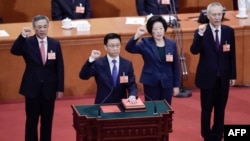 现任排名第三的中国国务院副总理胡春华（左一）被认为是出任下届中国总理的热门人选。图为现任中国排名第一的副总理韩正率领副总理孙春兰、胡春华、刘鹤和国务委员们在中国第十三届全国人民代表大会第一次会议第七次全体会议上宣誓就职（2018年3月19日）。