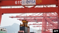 2021年9月7日，一台起重机在中国江苏省连云港市的港口将集装箱装载到卡车上。（法新社照片）