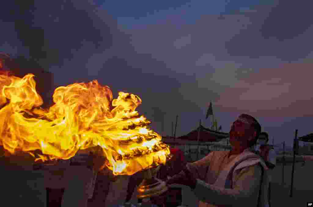 A Hindu priests perform an evening ritual &quot;Aarati&quot; at Sangam, the confluence of the rivers Ganges and Yamuna on Ramnavami in Prayagraj, India.