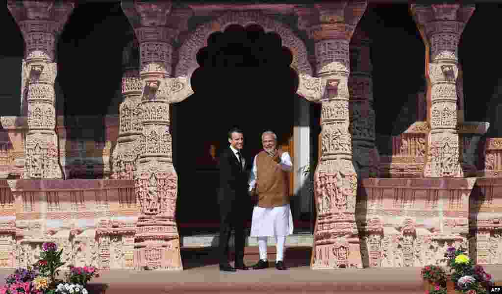 Indian Prime Minister Narendra Modi (R) welcomes French President Emmanuel Macron to the founding conference of the International Solar Alliance in New Delhi.