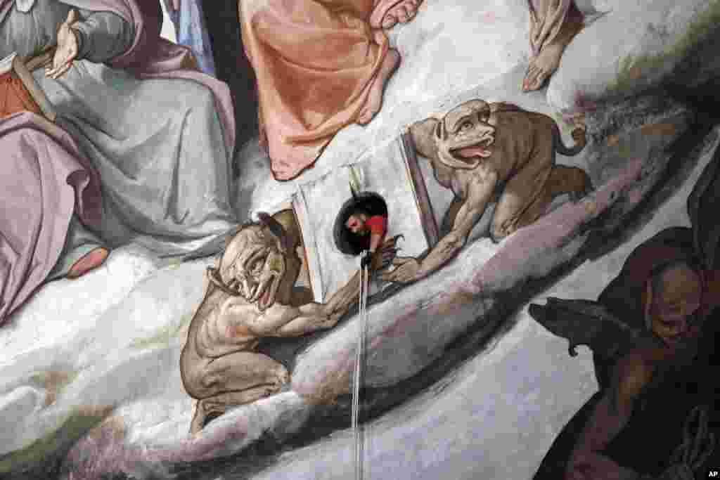 A technician inspects the frescoes of the 15th Century Brunelleschi's dome of Florence's Santa Maria del Fiore Cathedral, during a scheduled monitoring program.