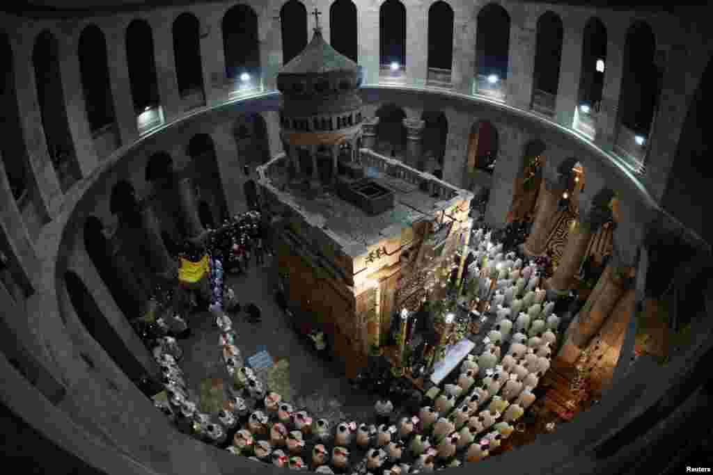 Worshipers take part in a procession during the Catholic Washing of the Feet ceremony on Easter Holy Week in the Church of the Holy Sepulchre in Jerusalem's Old City.