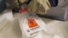 FILE - Batch of an experimental Ebola vaccine developed at the National Microbiology Laboratory in Winnipeg, Canada, arrives at Geneva University Hospital, Oct. 22, 2014.