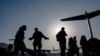 US Air Force airmen guide evacuees aboard a transport aircraft at Hamid Karzai International Airport in Kabul, Afghanistan, Aug. 24, 2021. (US Air Force photo)