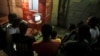 Congolese people wait for Congo's Independent National Electoral Commission (CENI) press conference to announce the results of the presidential election outside a bar in Kinshasa, Democratic Republic of Congo, Jan. 9, 2019.