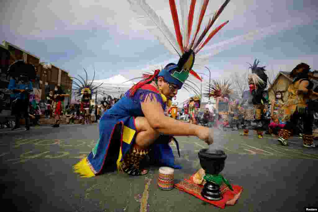The Kalpulli Ketzalcoatlicue and Kalpulli Tlaloctecuhtli dance groups perform at George Floyd Square during the People's Power Love Fest in Minneapolis, Minnesota, April 4, 2021.