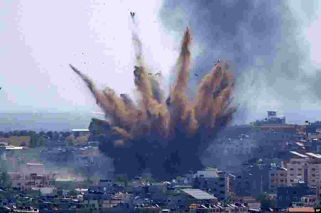 Smoke rises following Israeli airstrikes on a building in Gaza City. Palestinians are somberly marking the end of the Muslim holy month of Ramadan, as Hamas and Israel traded more rockets and airstrikes. 