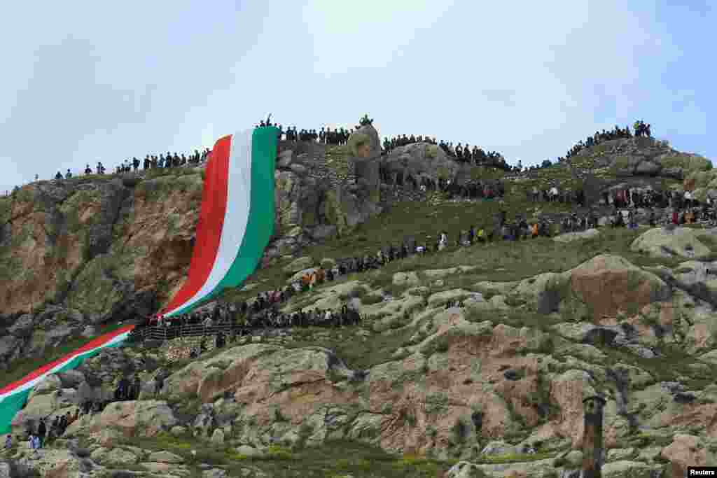 Iraqi Kurdish people celebrate Nowruz Day, a festival marking the first day of spring and the new year, amid the spread of COVID-19, in the town of Akra near Duhok, in Iraqi Kurdistan, March 20, 2021.