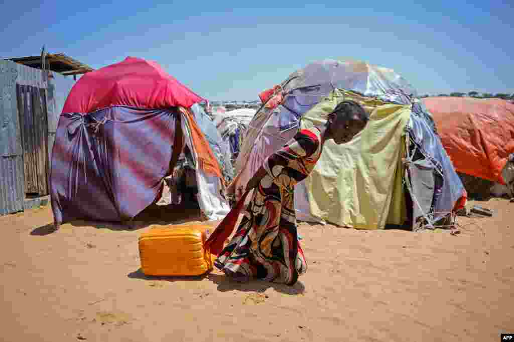 A girl drags a jerrycan filled with water from a well at the Tawakal IDP camp on the outskirts of Mogadishu, Somalia, on March, 21, 2018. World Water Day on March 22 calls attention on the importance of water, with this year&#39;s theme &quot;Nature for Water&quot; &ndash; exploring nature-based solutions to the water challenges we face in the 21st century.