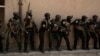 FILE - Soldiers from the 1st Battalion of the Iraqi Special Operations Forces are stacked against a building during a training exercise to prepare for the operation to retake Mosul from Islamic State militants, in Baghdad, Iraq, Aug. 13, 2016. 