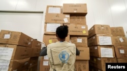 FILE - A World Food Program worker arranges relief packages for humanitarian aid for Africa to combat the outbreak of the coronavirus disease, at the Bole International Airport in Addis Ababa, Ethiopia, April 14, 2020. 