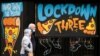 People walk past a mural on the windows of a closed pizza restaurant amid the outbreak of the coronavirus disease in Manchester, Britain, Feb. 22, 2021. 