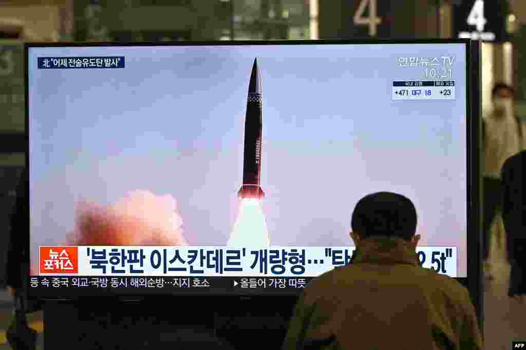 A man watches a television screen at Suseo railway station in Seoul showing news footage of North Korea's latest tactical guided projectile test.