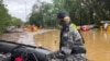 Royal Australian Navy personnel work with civilian emergency services to evacuate members of the public in Cairns, Australia, Dec. 18, 2023.