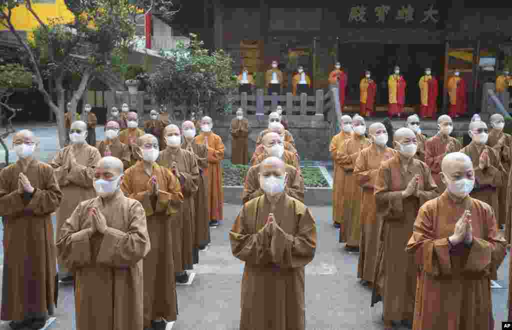 Monks and nuns pray together during Buddha's Birthday celebrations at the Lin Chi Temple in Taipei, Taiwan.