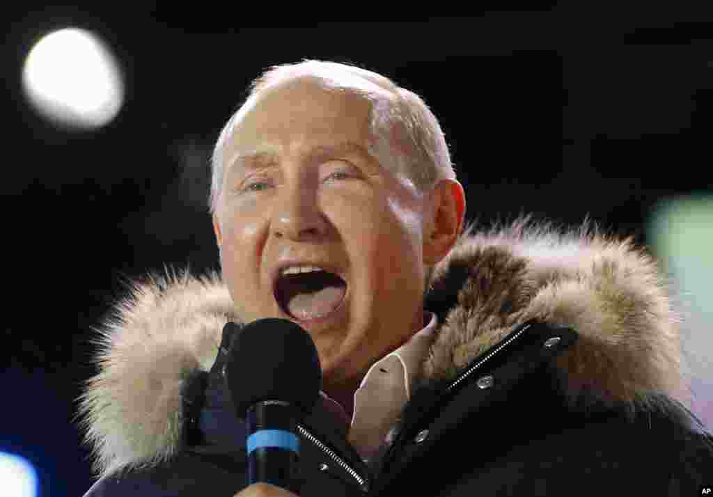 Russian President Vladimir Putin speaks to supporters during a rally near the Kremlin in Moscow, March 18, 2018. Putin won a fourth term as Russia's president, adding six more years in the Kremlin for the man who has led the world's largest country for all of the 21st century.