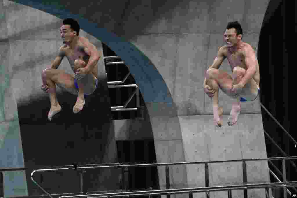 Mexico's Yahel Castillo Huerta and Juan Manuel Celaya Hernandez perform a dive in the men's synchronized 3-meter springboard final at the FINA Diving World Cup at the Tokyo Aquatics Centre in Tokyo, Japan.