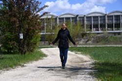 FILE - Local district mayor Krisztina Baranyi walks across the site where the construction of a top Chinese university, the Fudan's campus, is planned, in the 9th district of Budapest, Hungary, April 23, 2021.