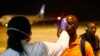 FILE - A health worker checks the temperature of a man arriving at Bata Airport, in Litoral, Equatorial Guinea, Jan. 14, 2015. 