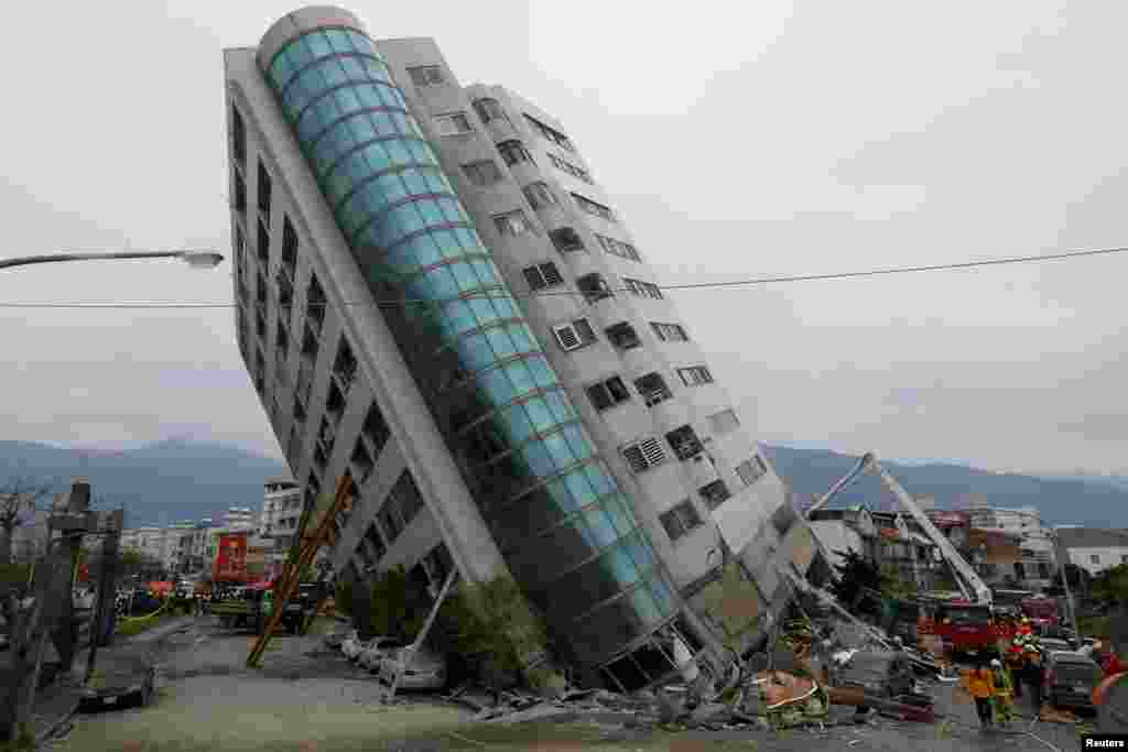 Rescue workers are seen by a damaged building after an earthquake hit Hualien, Taiwan.