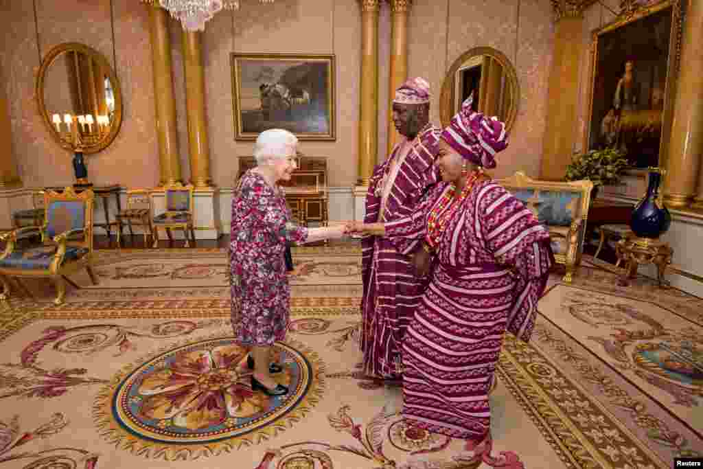 Britain's Queen Elizabeth meets George Adesola Oguntade, the High Commissioner of the Federal Republic of Nigeria, as he presents his Letter of Credence, with his wife, Mrs Oguntade, during a private audience at Buckingham Palace in central London.