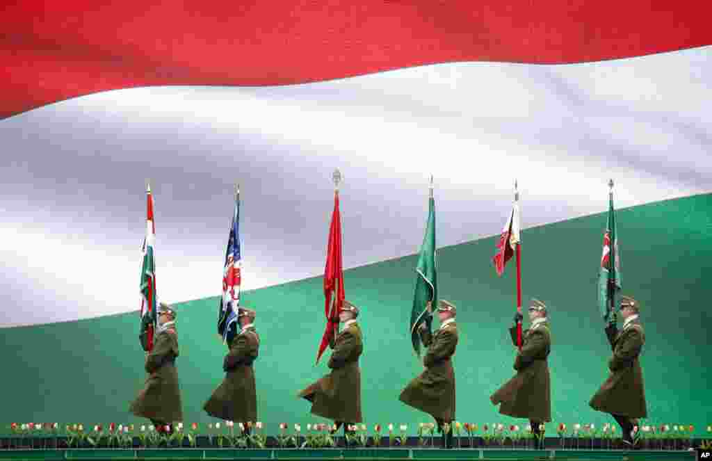 Hungarian soldiers march in Budapest, during a ceremony celebrating the country's national holiday.