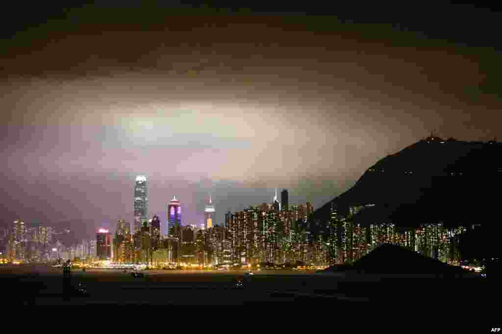 Ships sail in the waters off Hong Kong and the city's skyline, Feb. 25, 2018.