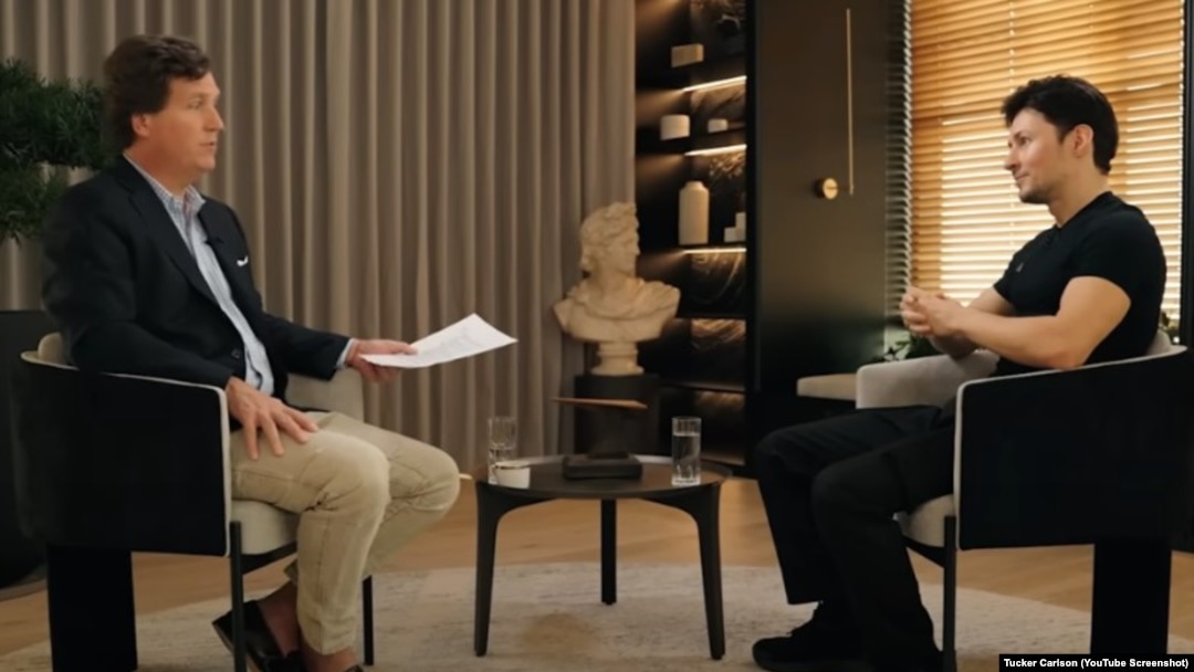 FILE - A YouTube screenshot of American conservative Tucker Carlson interviewing Russian IT businessman Pavel Durov in April 2024. The audience included scammers promoting dubious investment schemes on social media.