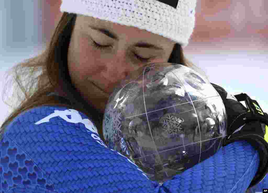 Italy's Sofia Goggia holds the women's World Cup downhill discipline trophy, at the alpine ski World Cup finals in Are, Sweden.