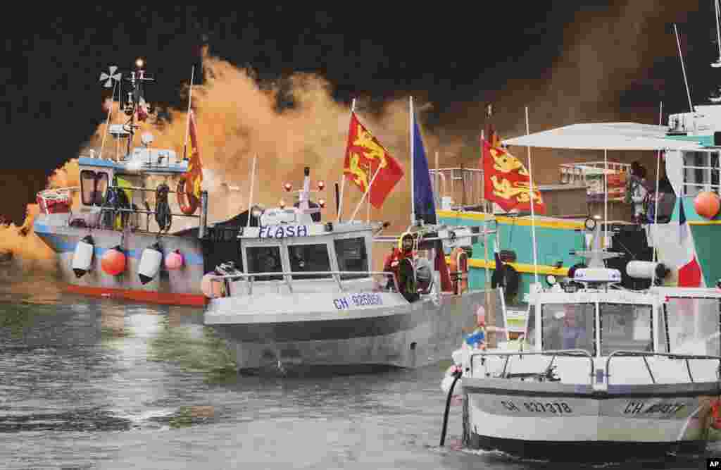 Fishing vessels at sea off the coast of Jersey, UK. French fishermen angry over loss of access to waters off their coast have gathered their boats in protest off the English Channel island of Jersey.