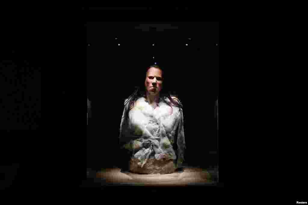 The reconstructed face of 'Dawn', a young woman who lived around 7,000 BC in a cave in Greece, is displayed during a presentation at the Acropolis museum in Athens, Greece. A Greek team led by an orthodontics professor has reconstructed the face of 'Dawn', from her remains, bringing to life a person who lived during the mesolithic period and uncovering details of her everyday existence.