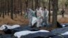 Місце масового поховання у звільненому від російських військ Ізюмі, Харківщина, 19 вересня 2022. REUTERS/Sofiia Gatilova