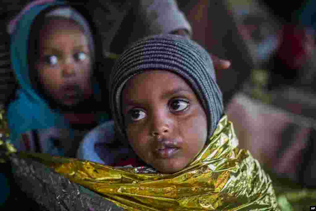 In this Friday Jan. 19, 2018 photo children from Eritrea rest on board the Spanish NGO Proactiva Open Arms rescue ship as the vessel heads to the Italian port of Pozzallo, in Sicily.