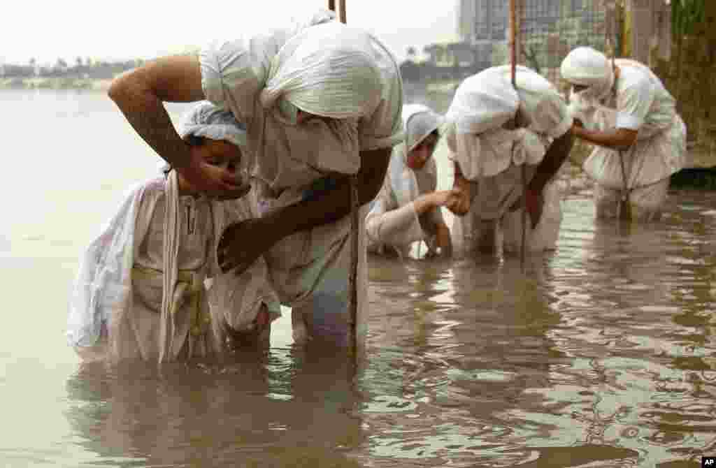 Followers of the Sabean Mandaeans, a pre-Christian sect that follows the teachings of John the Baptist, perform their rituals in the Tigris river during a celebration marking "Banja" or Creation Feast in central Baghdad, Iraq.