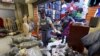 FILE - Police step over piles of suspected counterfeit clothing during a raid in Cape Town, South Africa, May 7, 2015. 