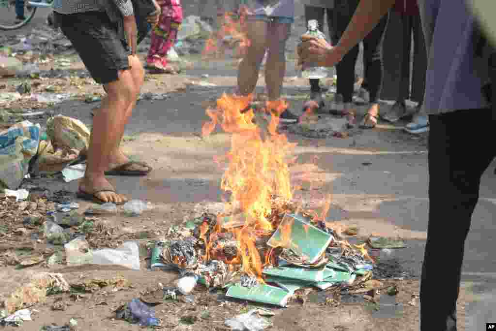 Anti-coup protesters burn constitution books at Tarmwe township in Yangon, Myanmar. Opponents of military government declared the country’s 2008 constitution void and put forward an interim replacement charter in a major political challenge to the ruling junta.