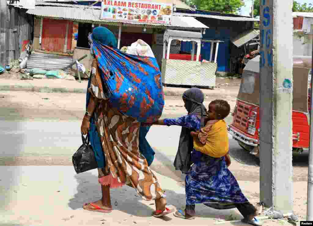 Civilians flee following gunfire between factions within Somalia's security forces near KM4 in Hodan district of Mogadishu, Somalia.
