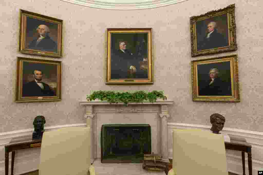 The Oval Office of the White House is newly redecorated for the first day of President Joe Biden's administration, Jan. 20, 2021, in Washington, including a pairing of former President Franklin D. Roosevelt over the mantle of the fireplace.