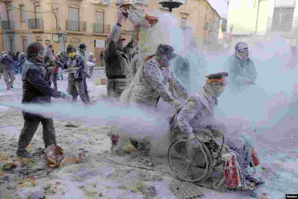 Revellers battle with flour and eggs during the traditional Els Enfarinats (The Floured) festival in Ibi, Alicante Province, Spain.